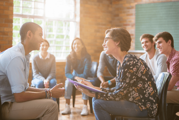 Clinician works with patients in a group therapy session